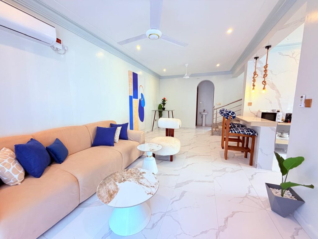 Spacious open-plan living room with marble floors
