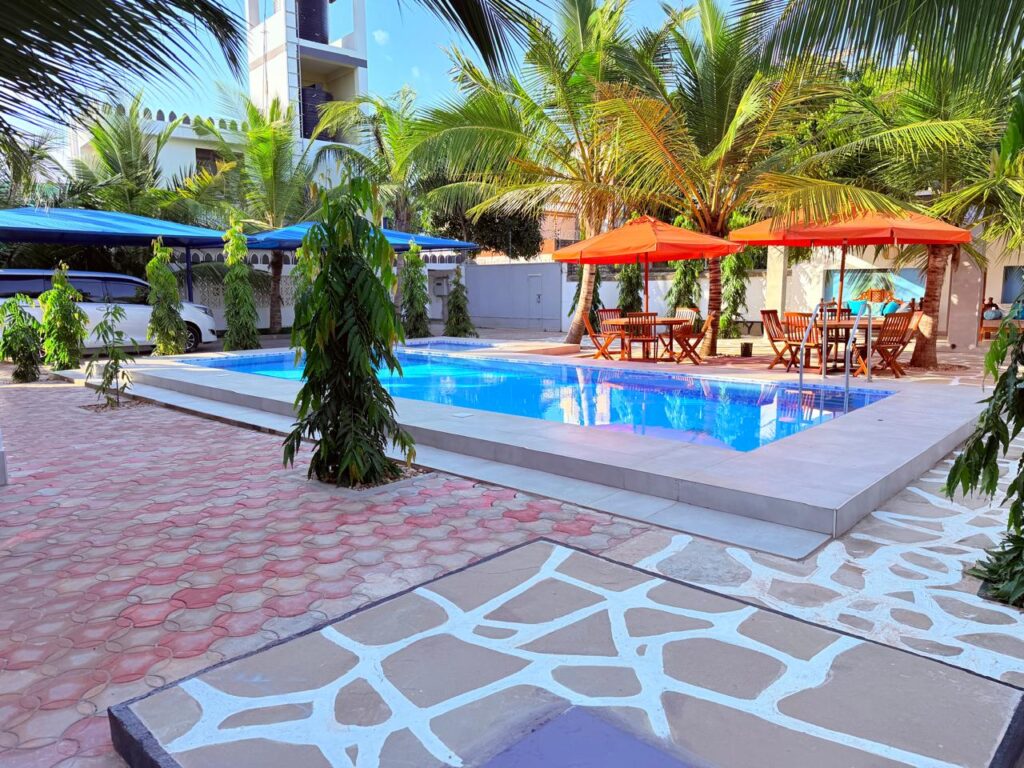 Pool area with umbrellas and coconut palms