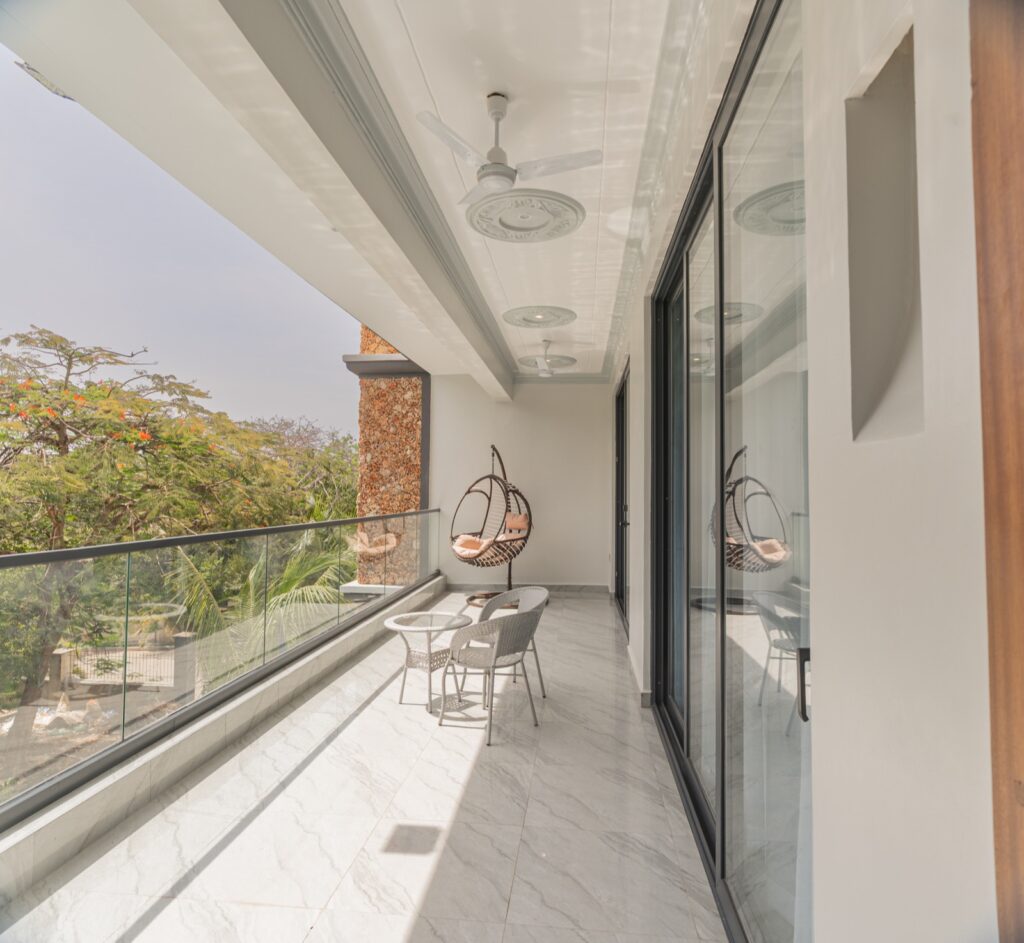 Private upper balcony with hanging egg chair and garden views