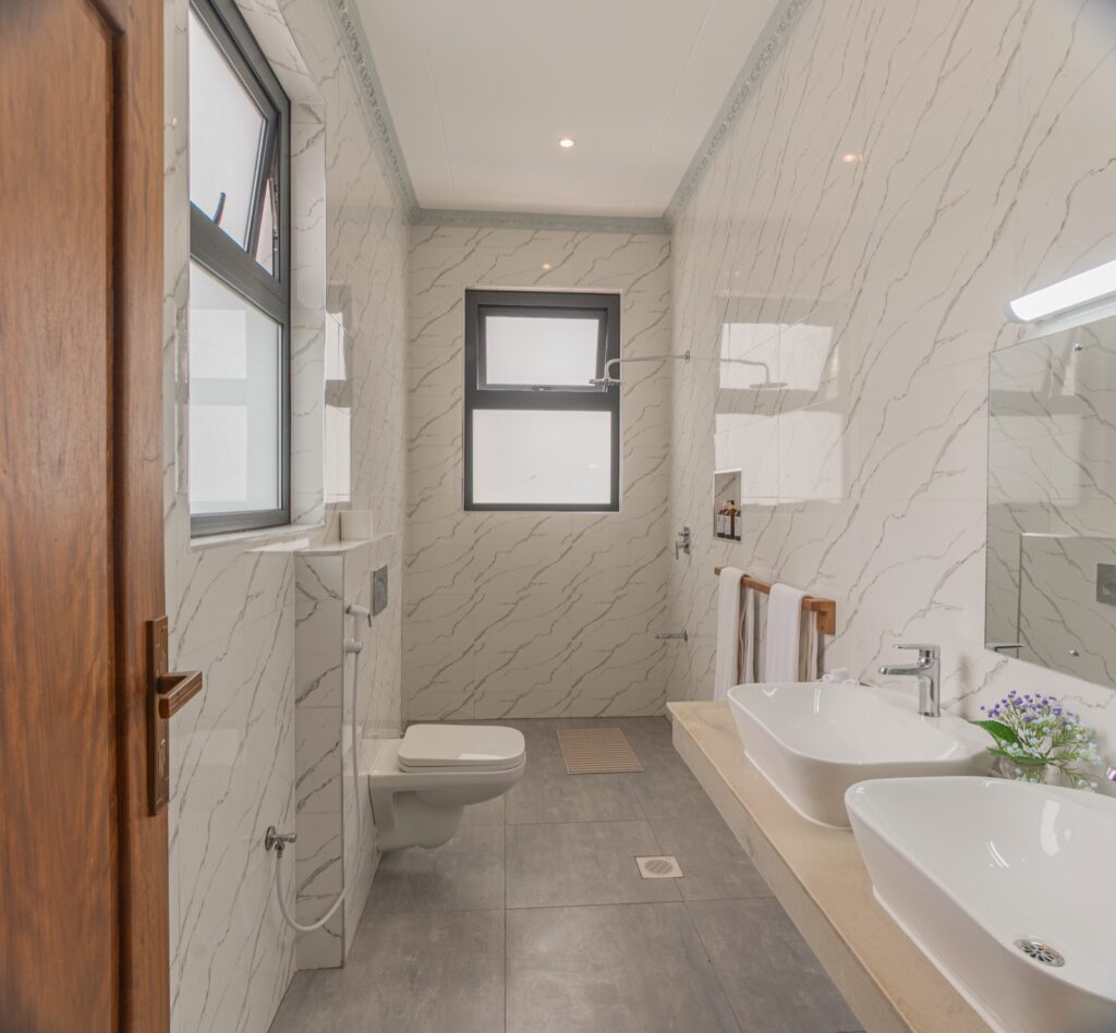 Marble en-suite bathroom with double vanity and walk-in shower