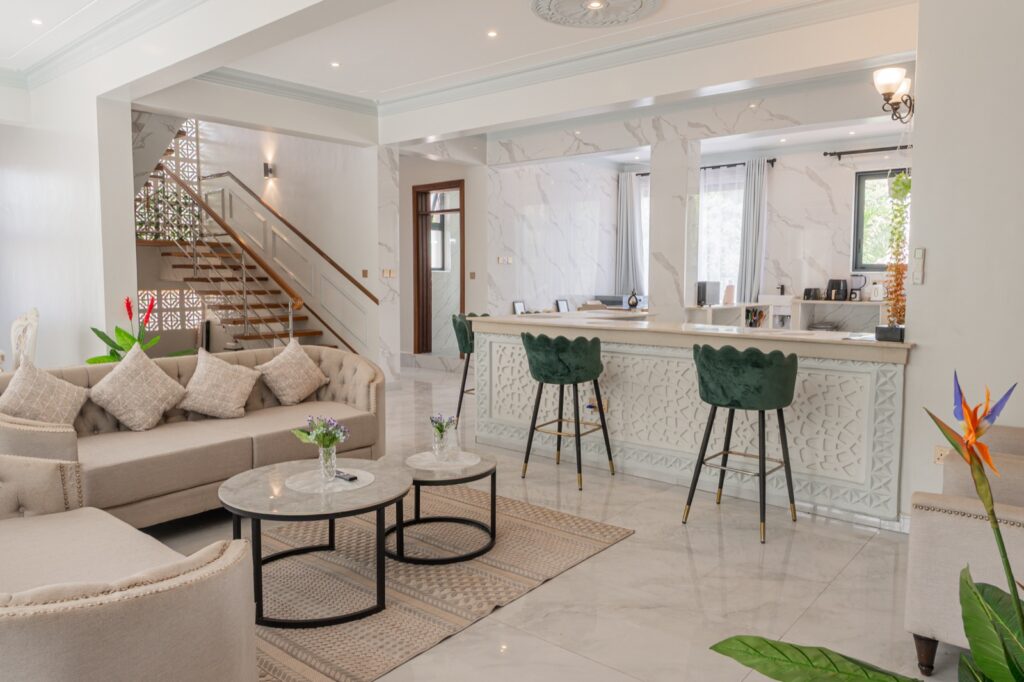 Open-plan living room with bar and Chesterfield sofas