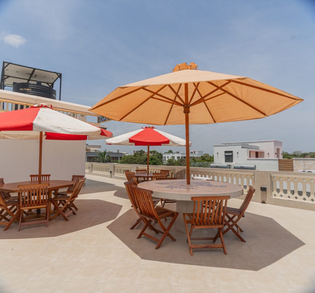 Rooftop terrace with teak dining sets and ocean views